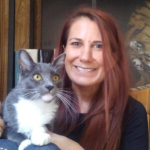 Professor Cheryl Abbate with her grey and white cat Tom.